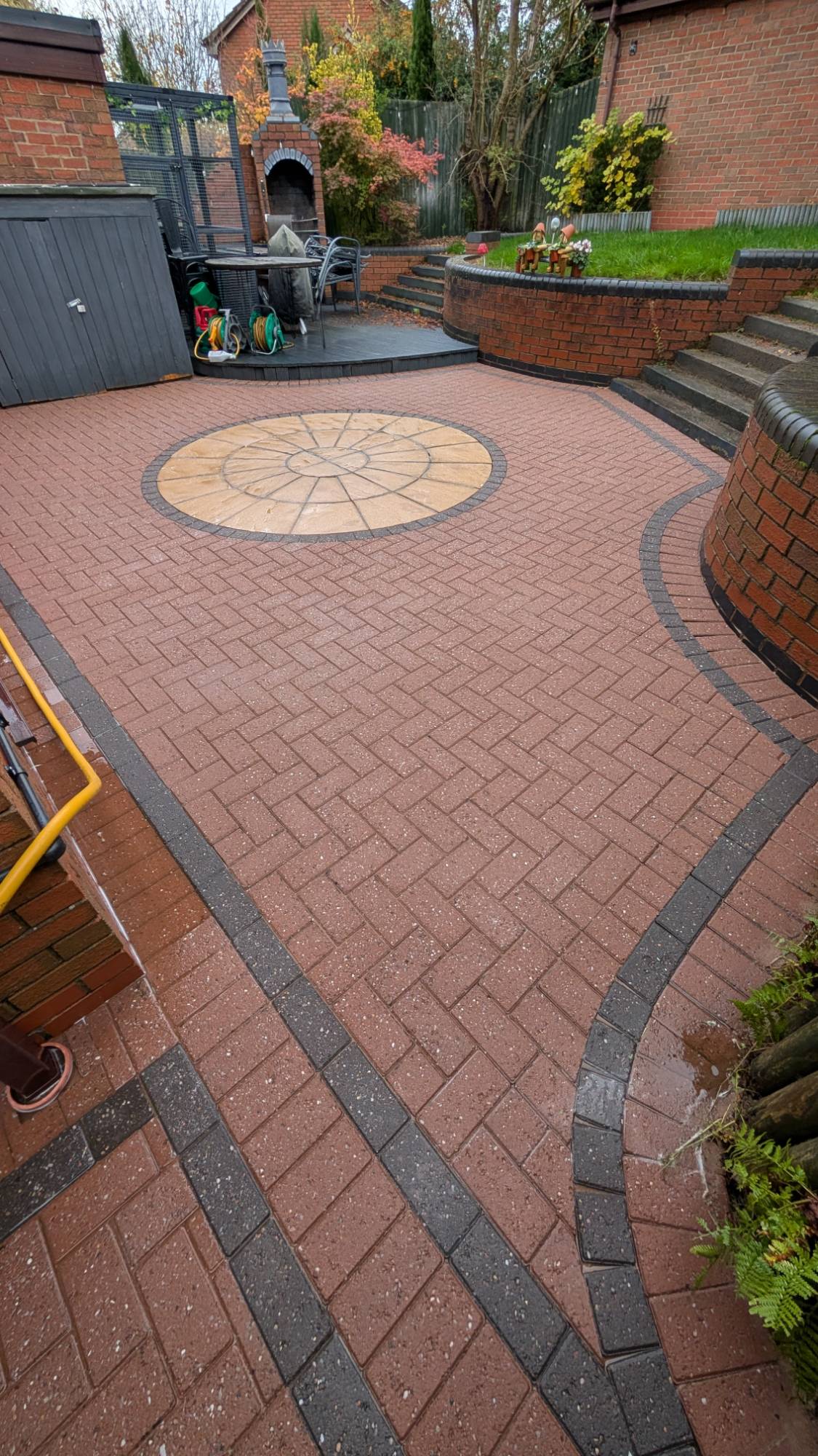 Block paving patio with circular feature pressure washed clean — patio cleaning Yorkshire