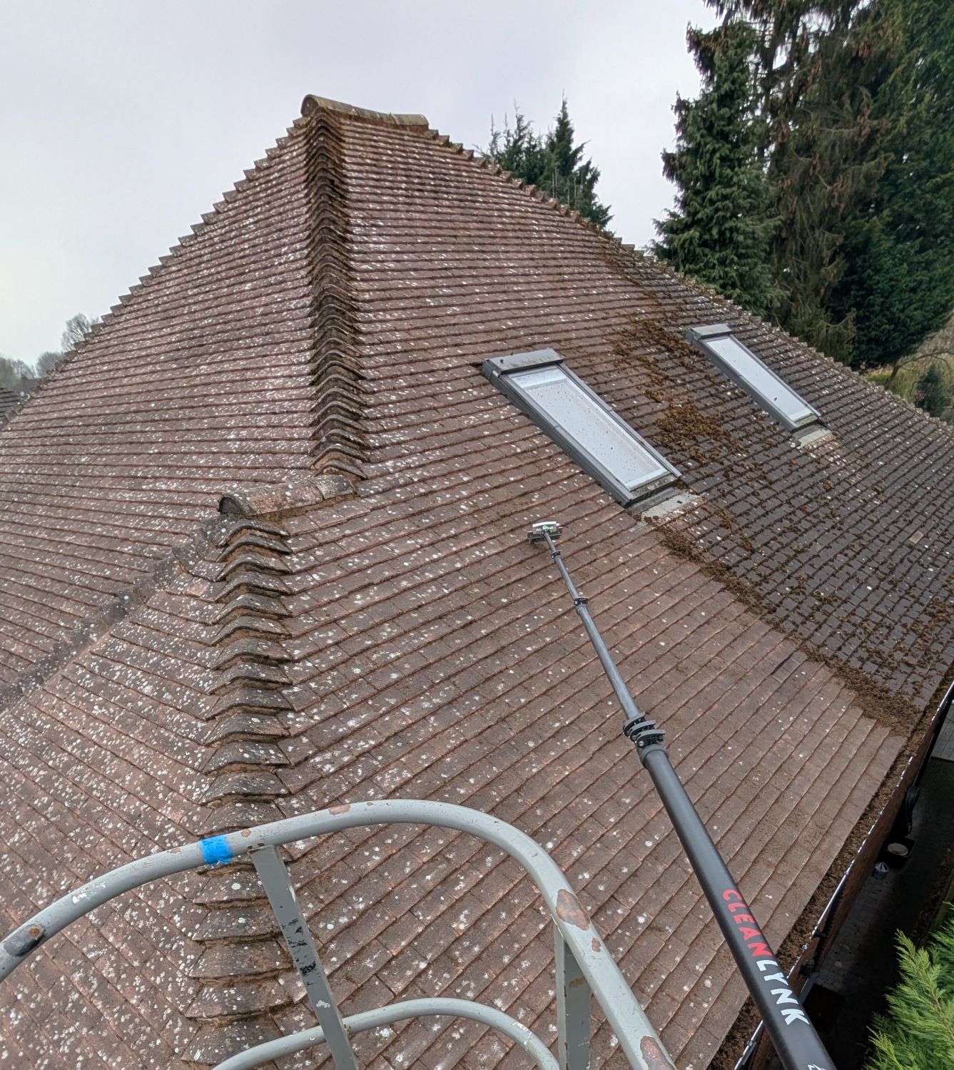 Roof moss removal in Keighley &mdash; manual scraping in progress by Hugo's