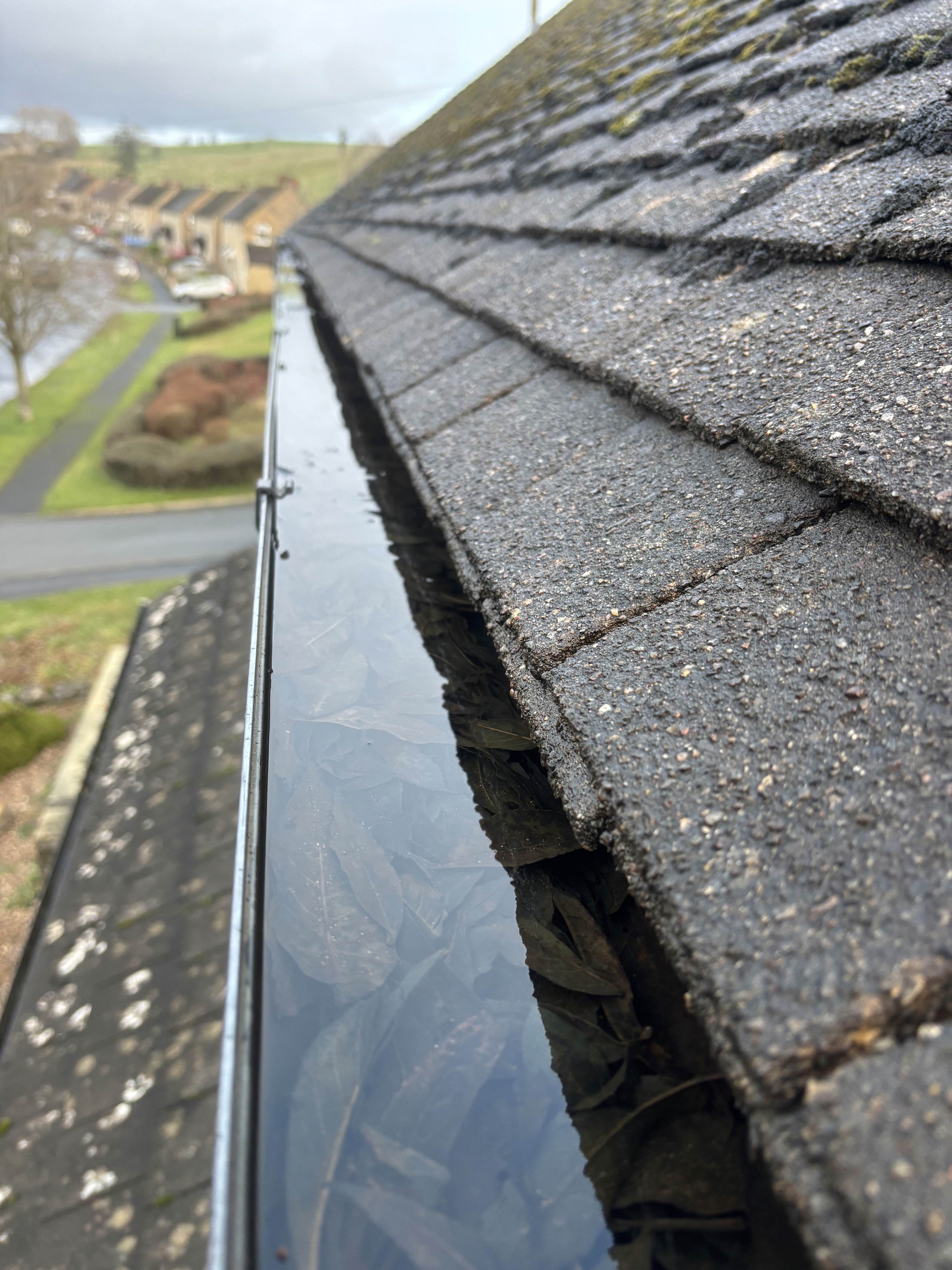 blocked downpipe and overflowing gutter — Yorkshire property